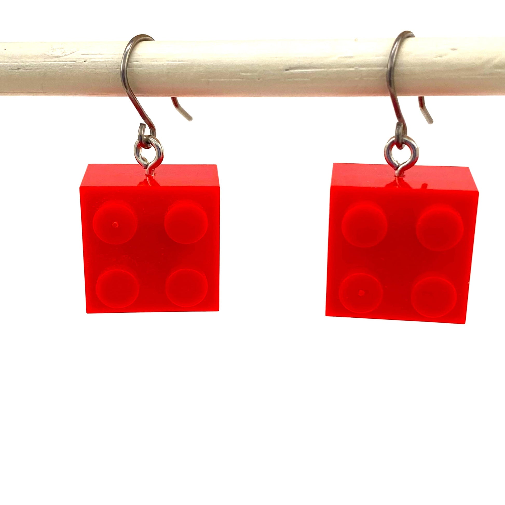 Red titanium LEGO block earrings on a white background
