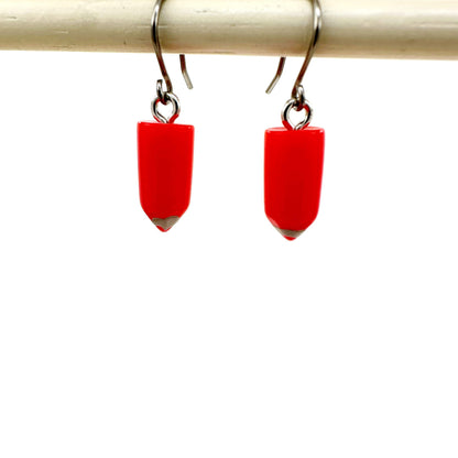 Pencil earrings with a titanium hook on a white background. red