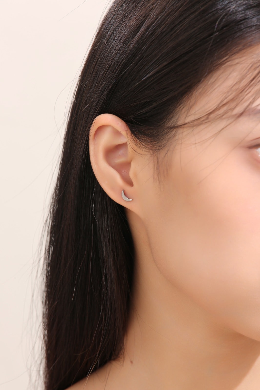 Moon  Studs Titanium Studs with titanium backs shown on a white woman
