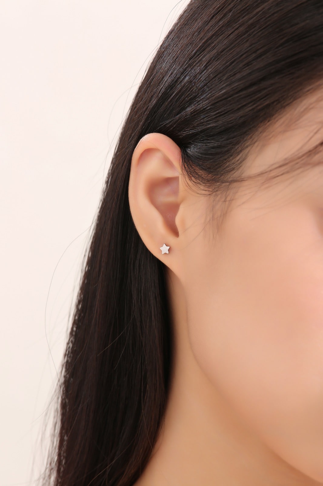 Star Studs Titanium Studs shown on a white woman