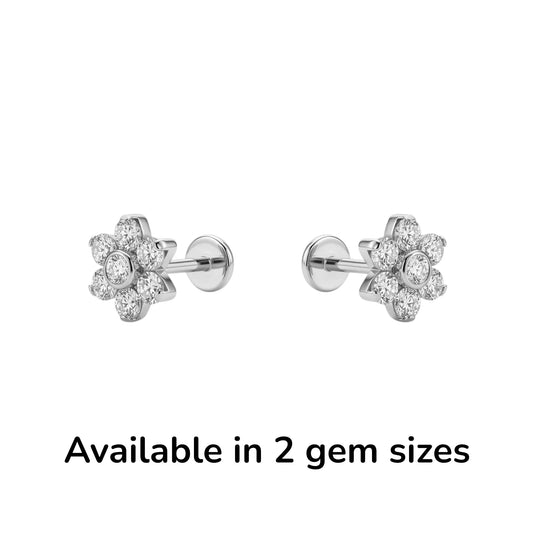Titanium flower-shaped earrings on a white surface with text about product details