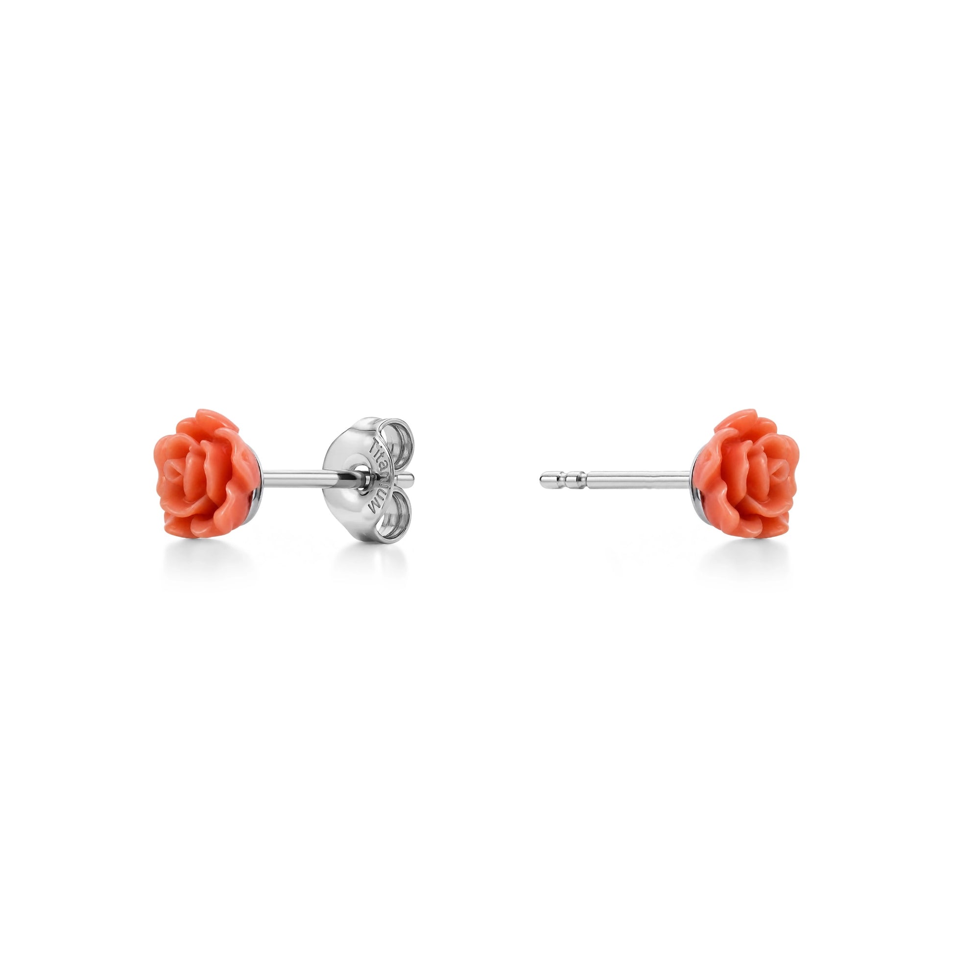 A pair of titanium stud earrings featuring beige rose-shaped enamel tops, shown on a clean white background with one earring facing forward and the other showing the backing.