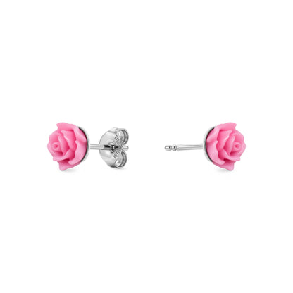 A pair of titanium stud earrings featuring pink rose-shaped enamel tops, shown on a clean white background with one earring facing forward and the other showing the backing.