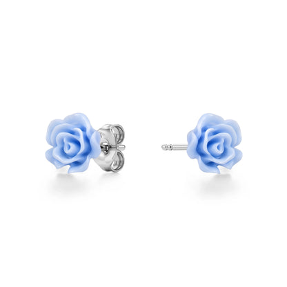 A pair of titanium stud earrings featuring pastel blue rose-shaped enamel tops, shown on a clean white background with one earring facing forward and the other showing the backing.