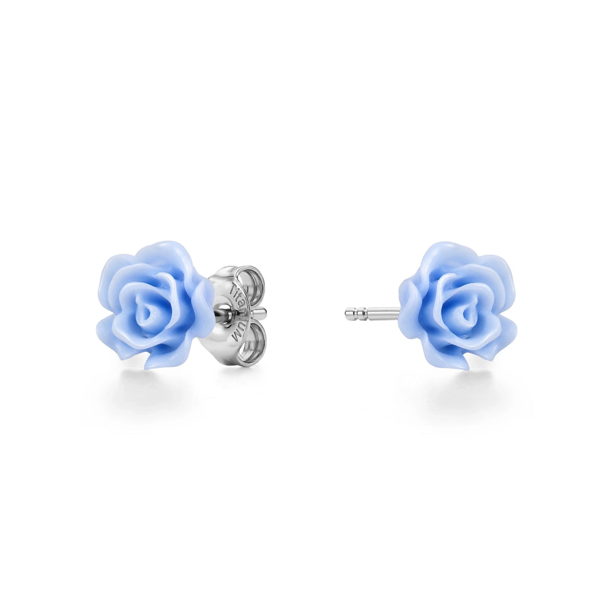 A pair of titanium stud earrings featuring pastel blue rose-shaped enamel tops, shown on a clean white background with one earring facing forward and the other showing the backing.