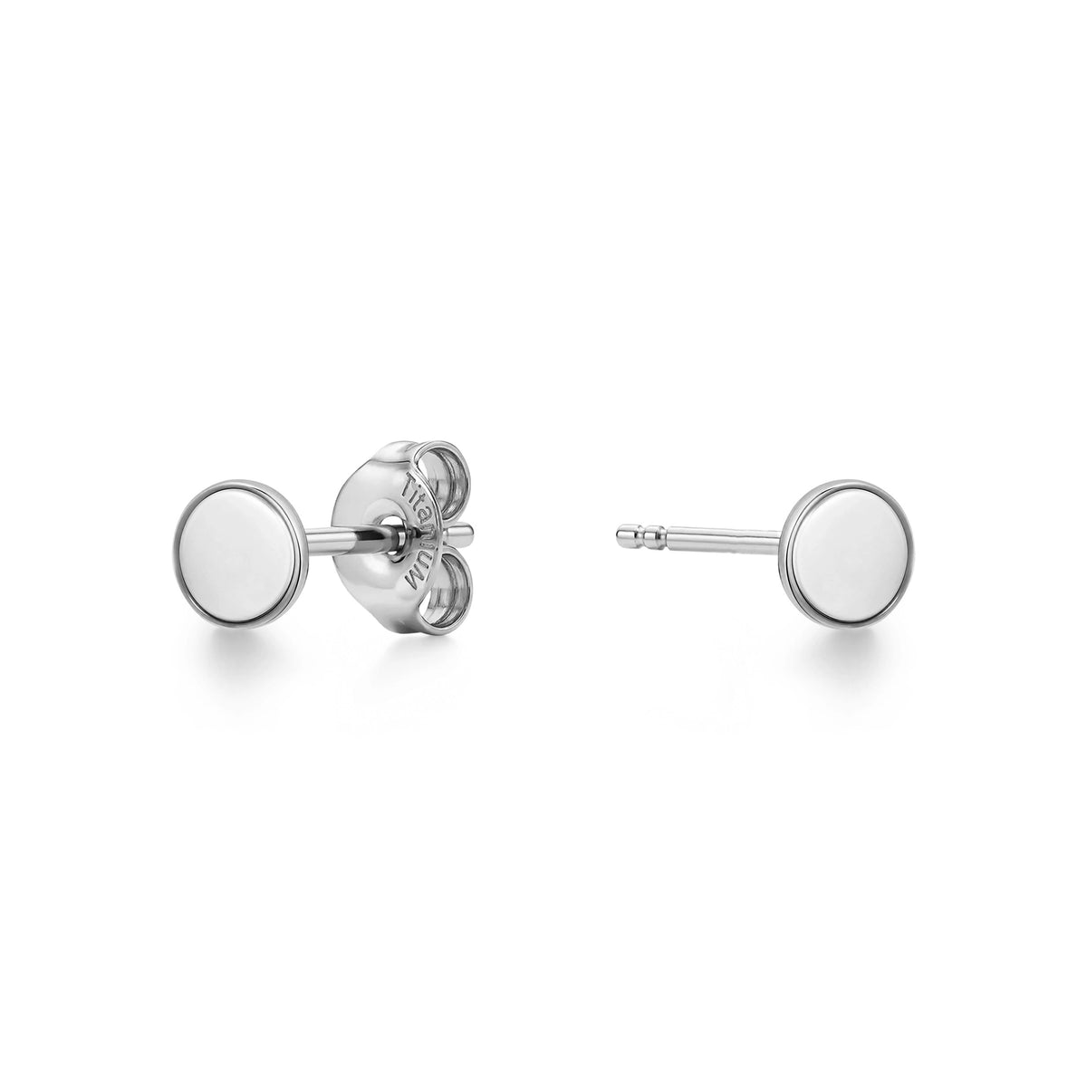 A pair of titanium stud earrings with flat circular disc faces, one shown from the front and the other from the side/back view, on a clean white background.