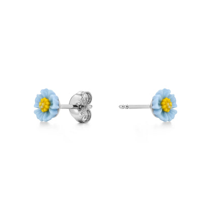A pair of titanium stud earrings featuring pastel blue and yellow marigold-shaped enamel tops, shown on a clean white background with one earring facing forward and the other showing the backing.