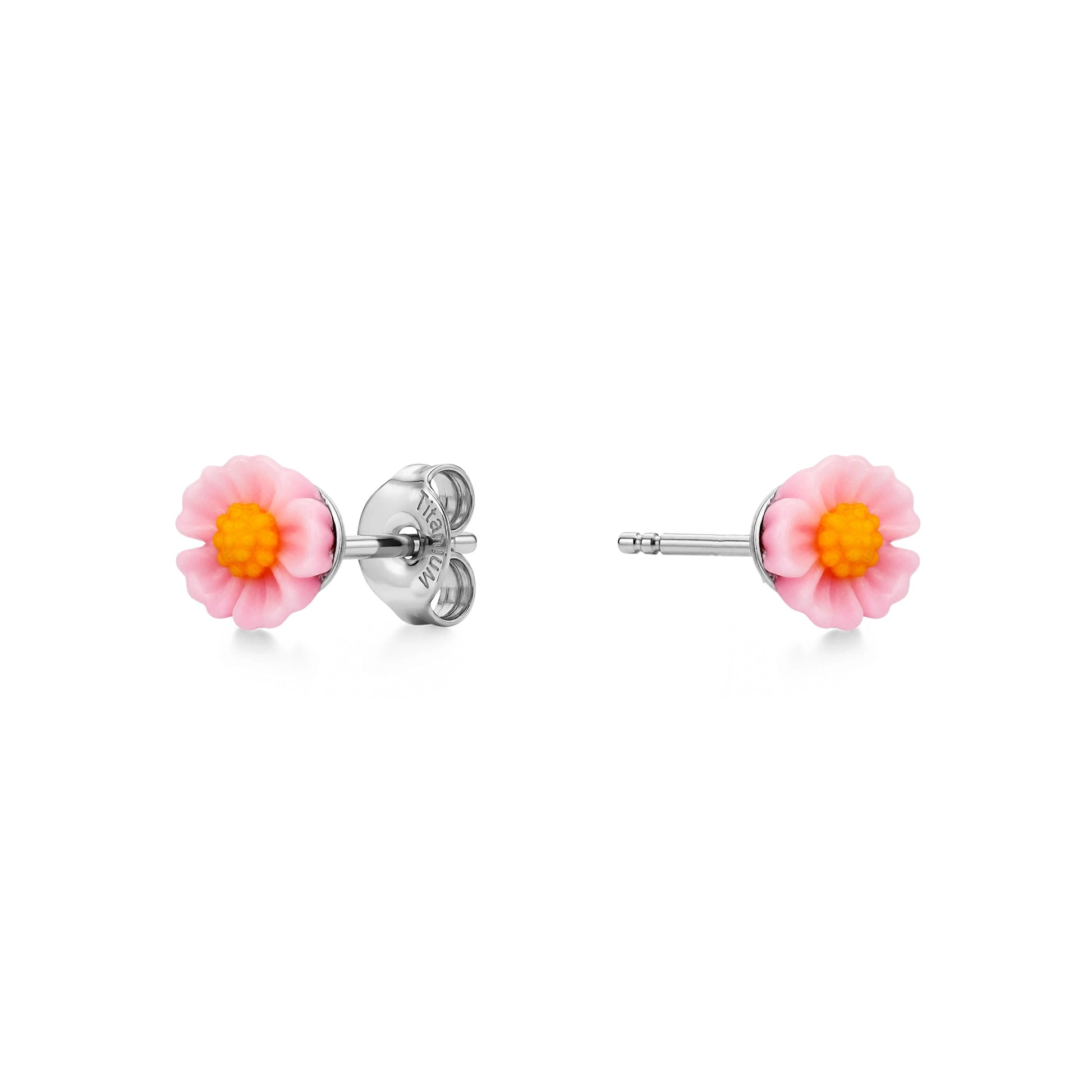 A pair of titanium stud earrings featuring light pink and yellow marigold-shaped enamel tops, shown on a clean white background with one earring facing forward and the other showing the backing.