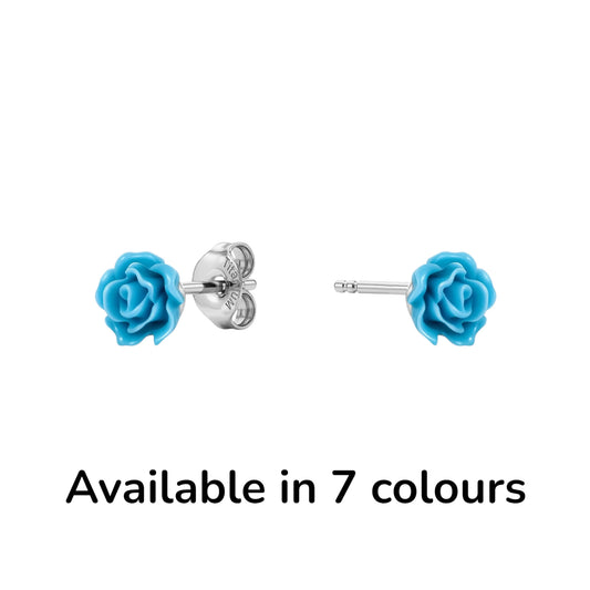 A pair of titanium stud earrings featuring bright blue rose-shaped enamel tops, shown on a clean white background with one earring facing forward and the other showing the backing. with the text 'Available in 7 colours' below.