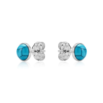 Pair of titanium earrings with light blue stones on a white background