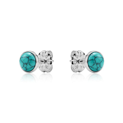 Pair of titanium aqua blue stud earrings on a white background
