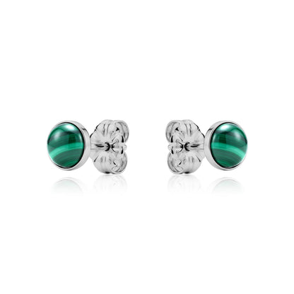 Pair of titanium earrings with green gemstones on a white background