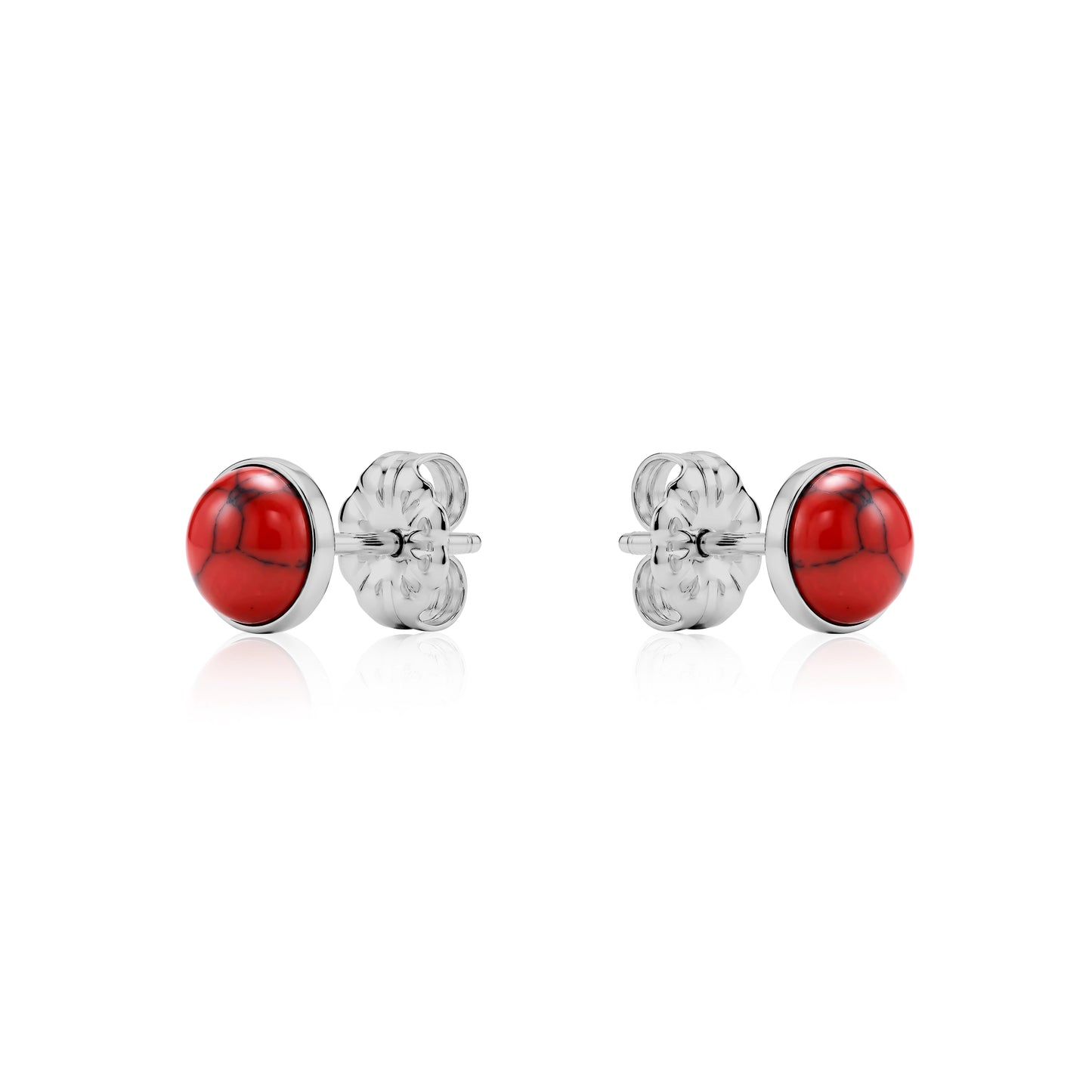 Pair of titanium earrings with red stones on a white background