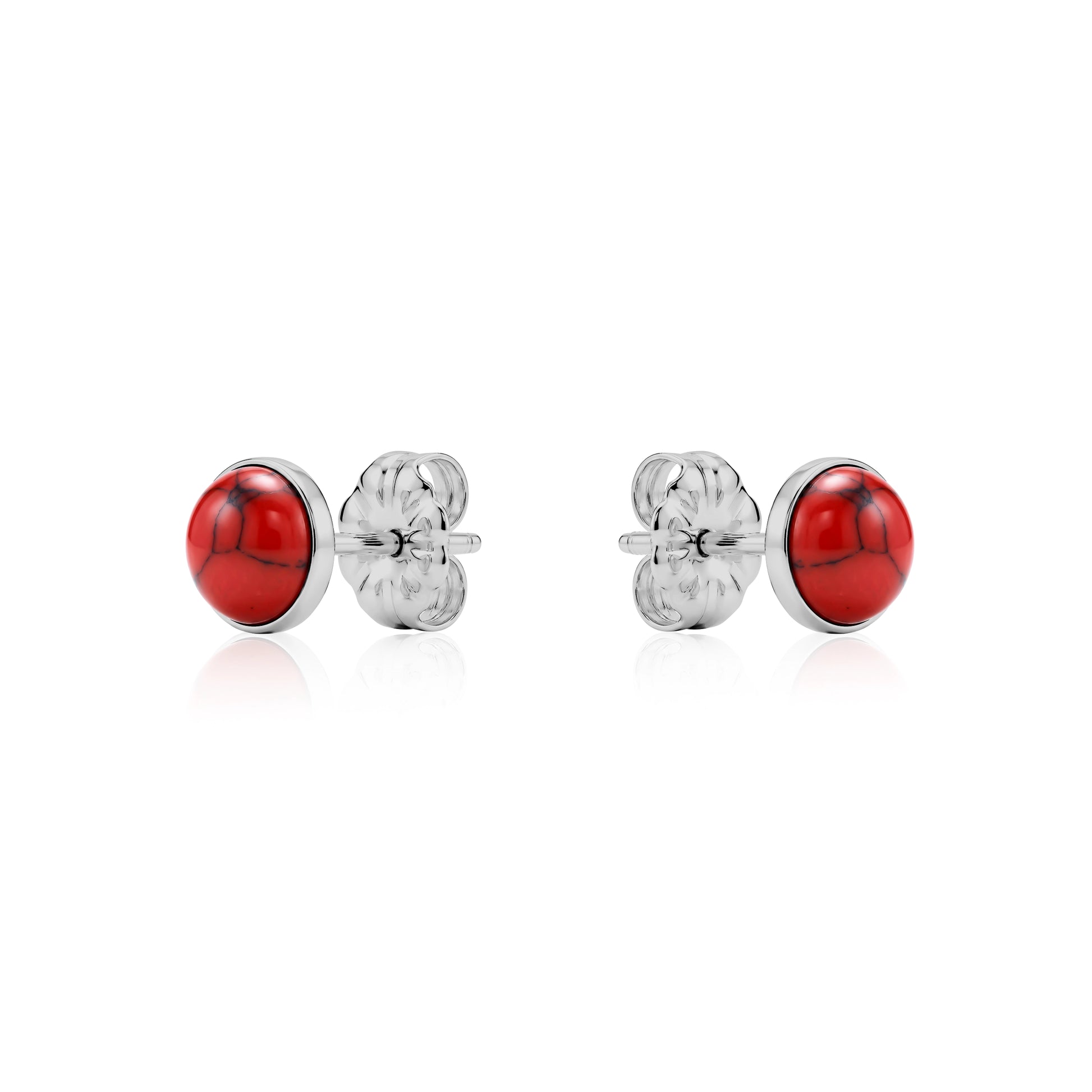 Pair of titanium earrings with red stones on a white background