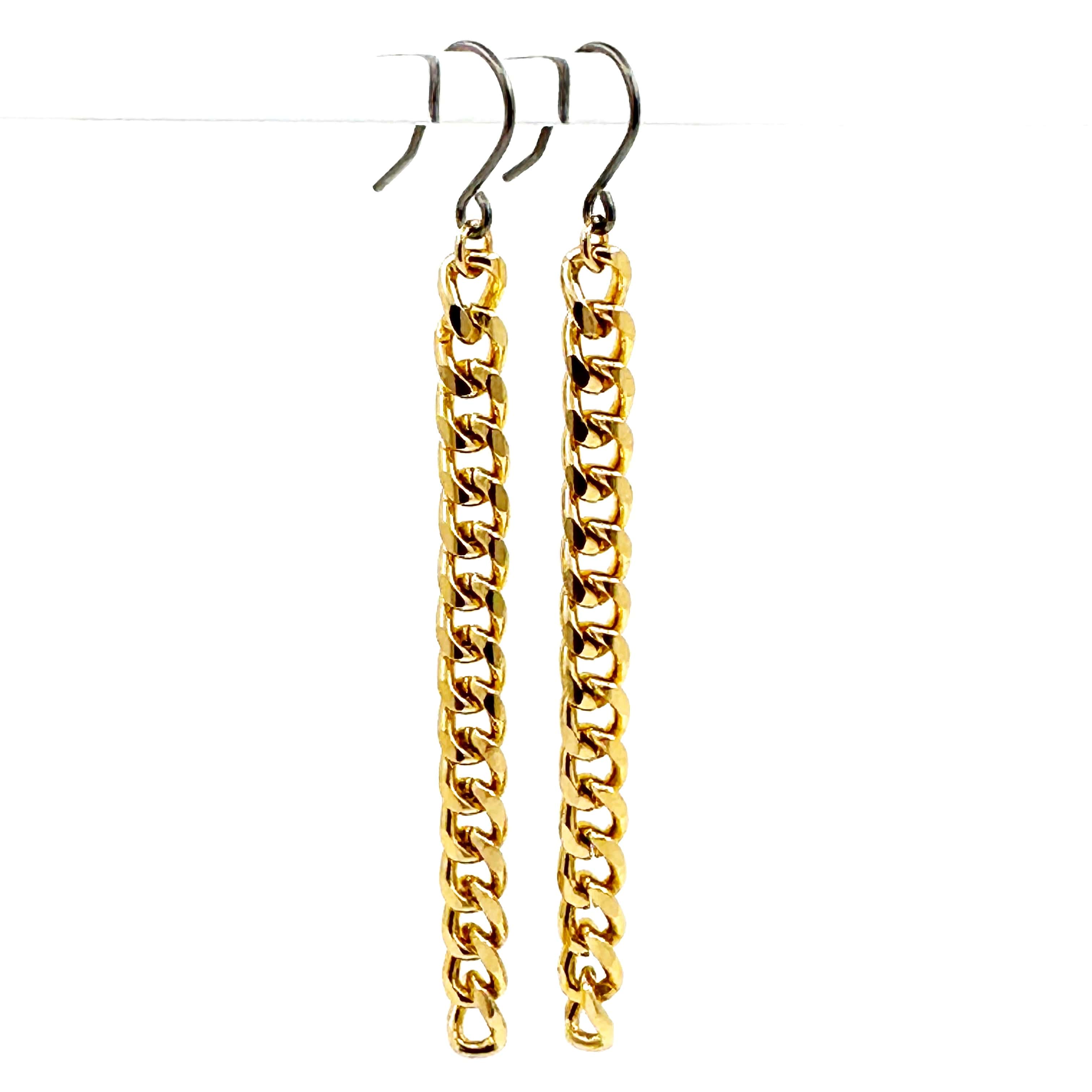 Small gold chain earrings with a titanium hook on a white background