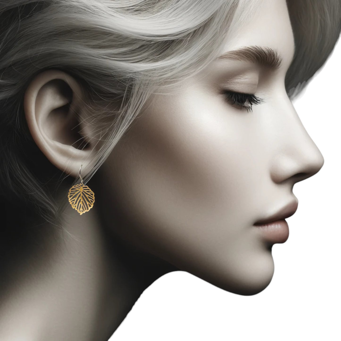 Small Monstera Leaf Earrings with a titanium hook on a white young woman.