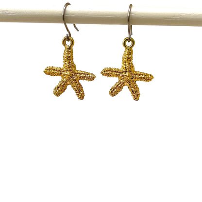 Starfish Charm earrings with a titanium hook on a white background