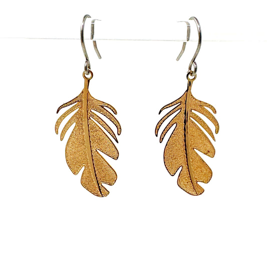 Stylized monstera leaf earring with a titanium hook on a white background