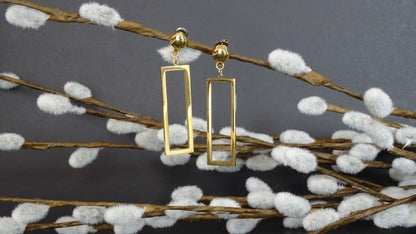 TI-GO Rectangle mirrored gold earrings. Detachable earrings for a truly hypoallergenic jewellery on a grey background