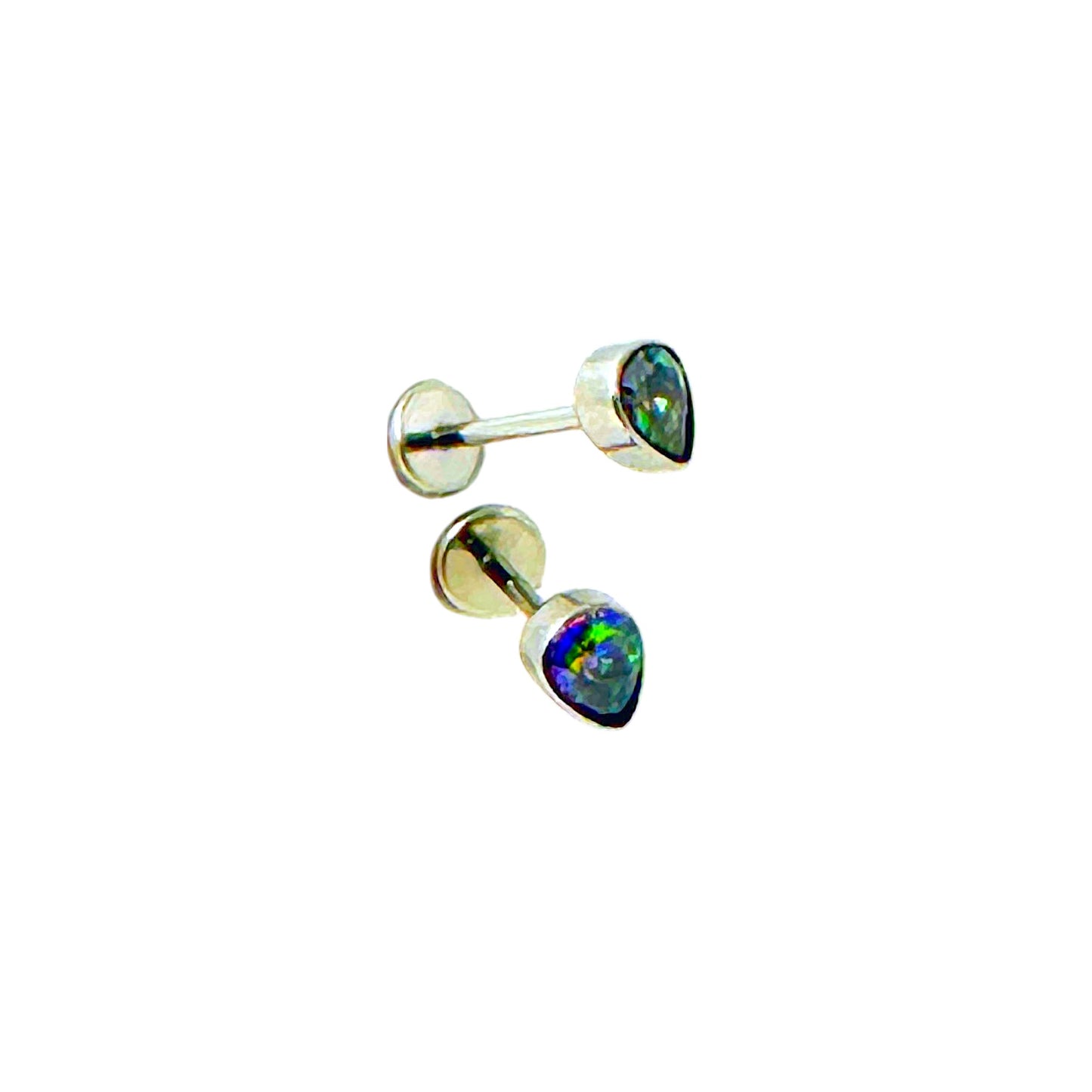 Pair of titanium flat back push in studs with rainbow-colored gemstones on a white background