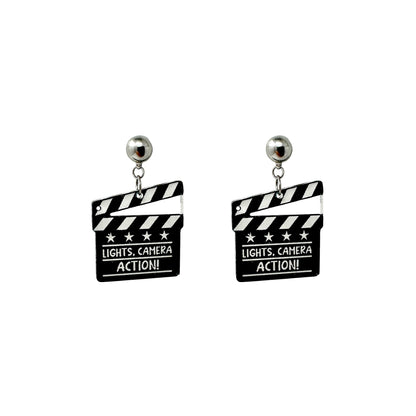Lights camera action earrings with a titanium magnetic stud on a white background