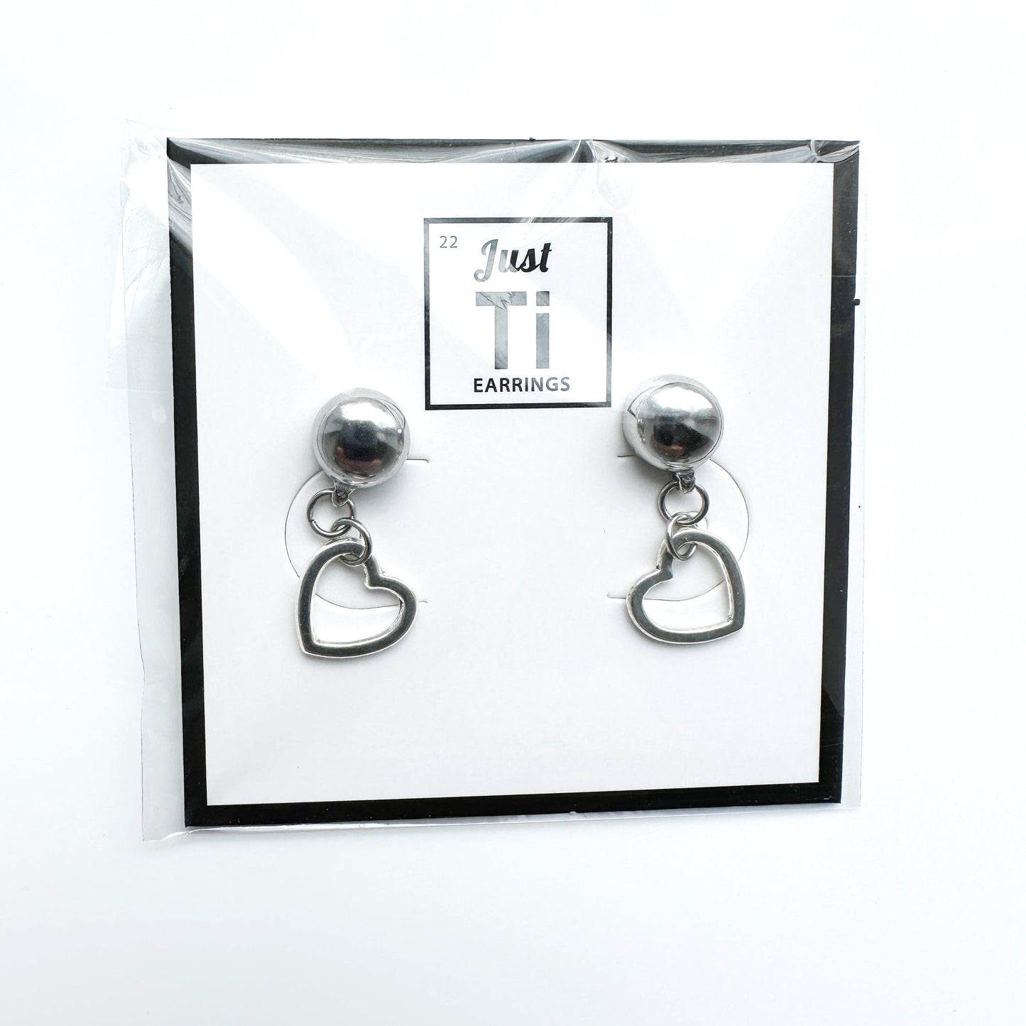 Ti-Go Mini silver heart earrings. Detachable earrings for a truly hypoallergenic jewellery on a white background card