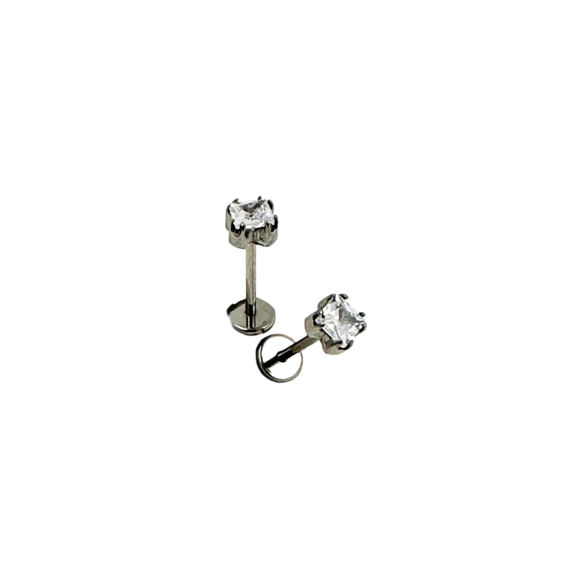 Pair of titanium stud earrings with 4 mm square  gemstones on a white background