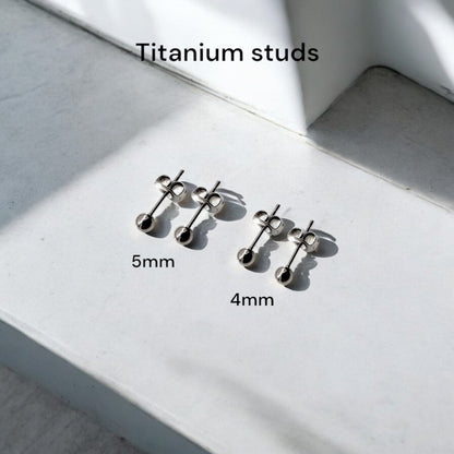 Titanium Ball Studs solid titanium studs and backs Feature a small and minimal design on a stonea white background