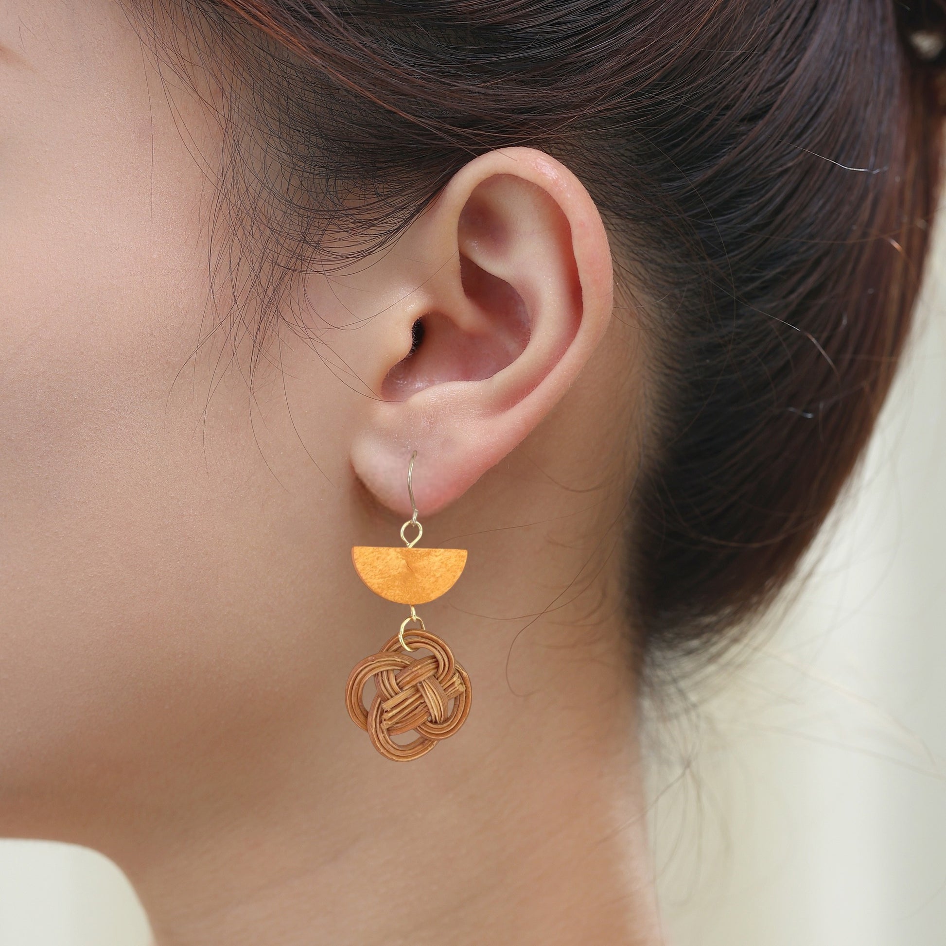 Bohemia Style Rattan Wooden Geometric Earrings with titanium hook on a white young woman