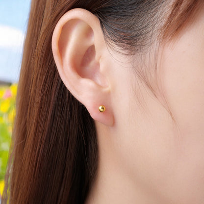 Titanium Flat Back Push-In Gold Ball 4 diameter Stud 20 gauge on a woman