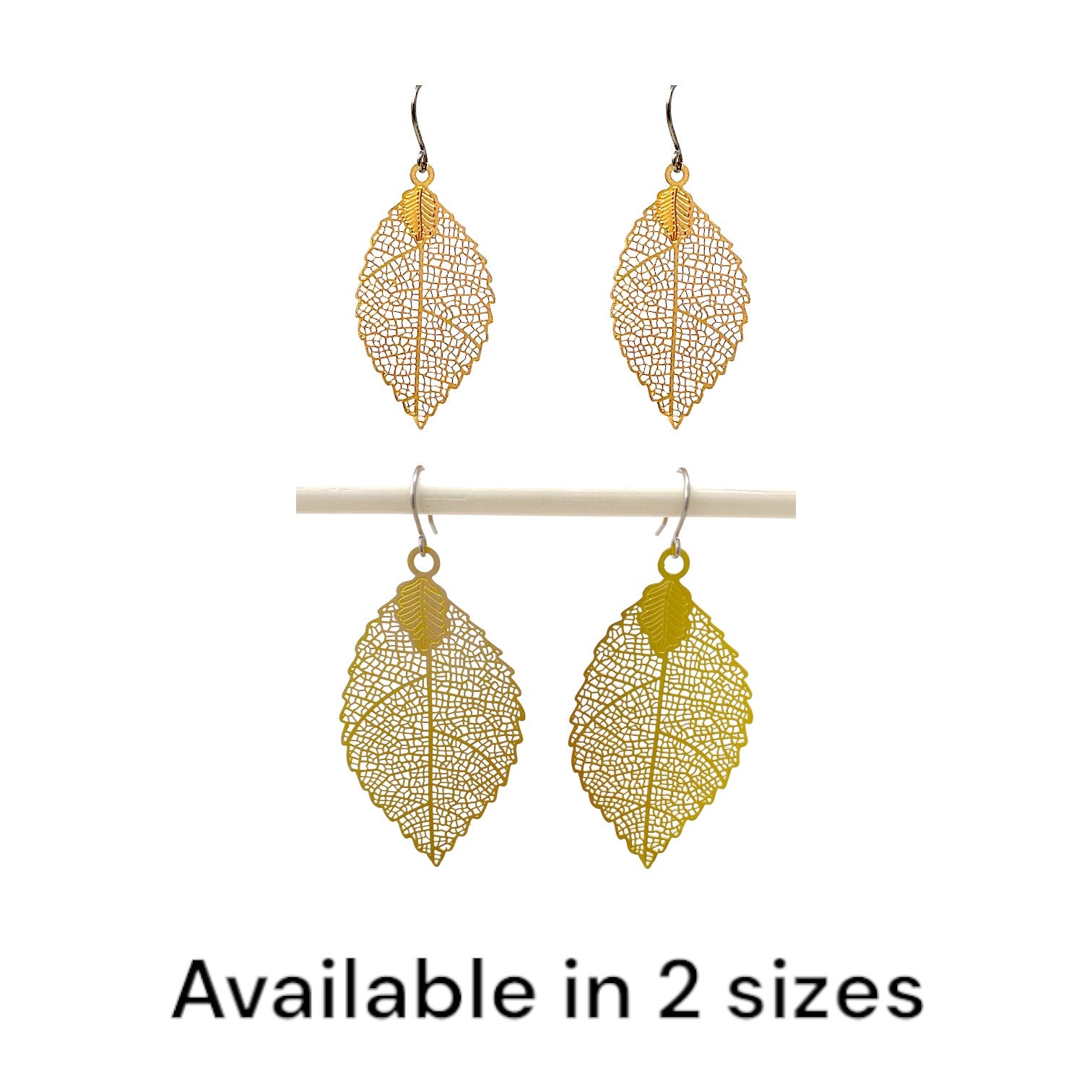 Gold disc leaf earring and a titanium hook on a white background