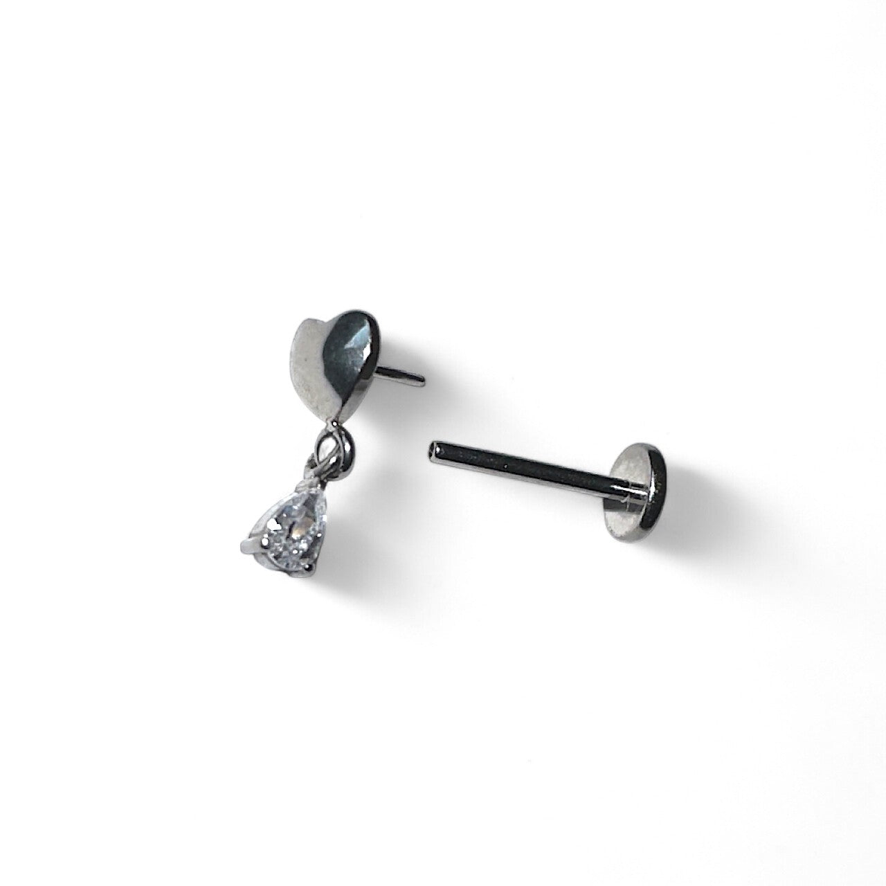 Titanium earring with heart and teardrop hanging gem on a white background