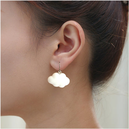 White Cloud earrings with titanium hook. on a white young woman