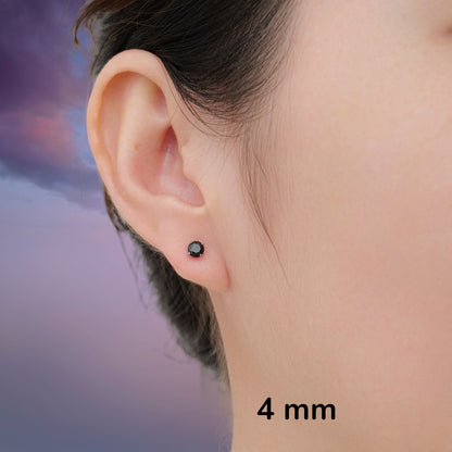 Close-up of an ear wearing a black titanium stud earring with '4 mm' text.
