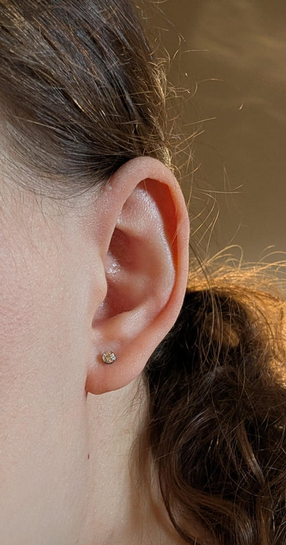 Titanium 3mm Gem Studs close up on a  Kateryna Zhukova