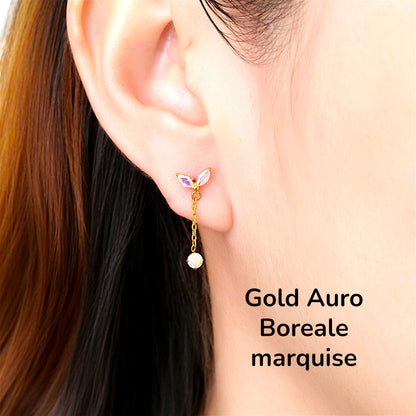 titanium flat back threadless 20 gauge earrings with Auro-Boreale leaf like tops and gold chains on a woman
