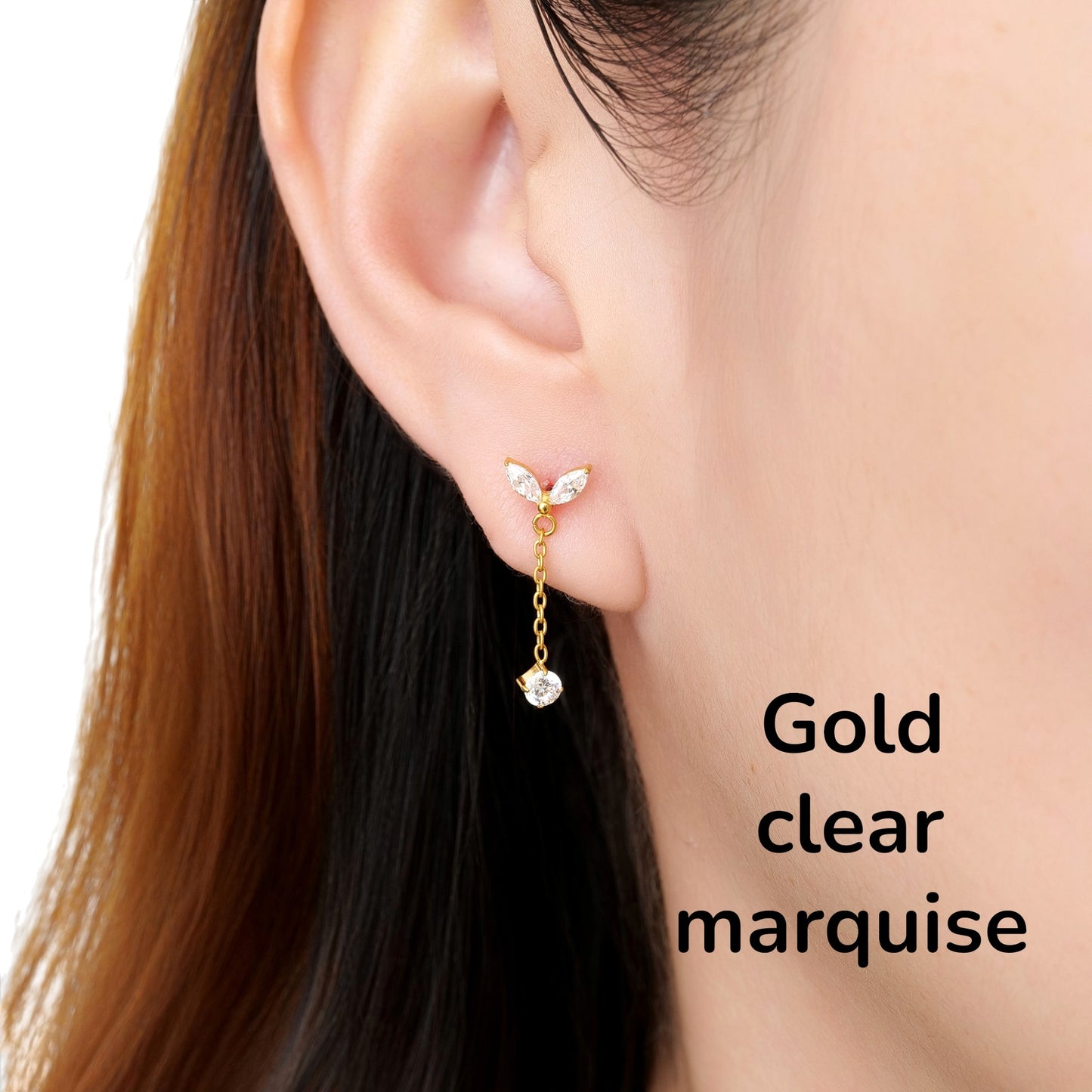 Close-up of an ear wearing a gold clear leaf-shaped titanium flat back earring on a woman
