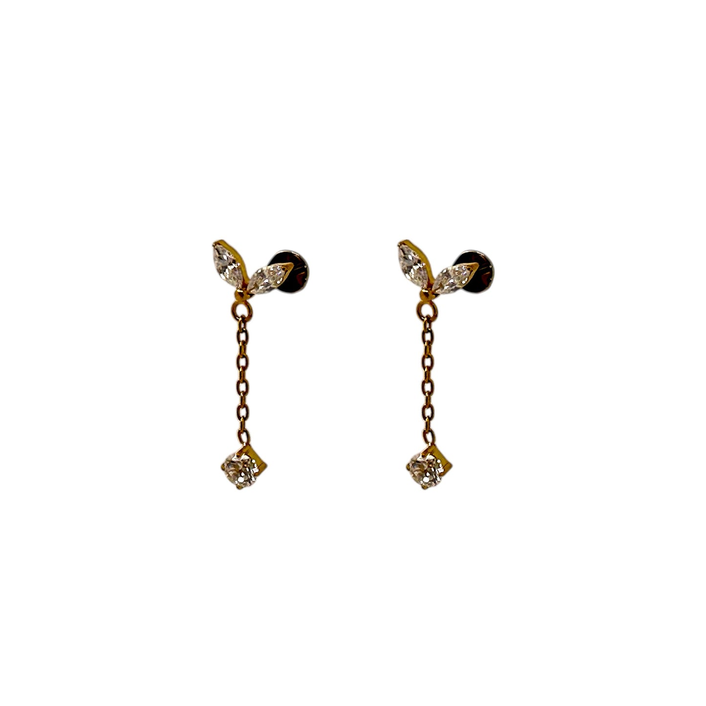 Pair of titanium flat back threadless 20 gauge earrings with clear leaf-like tops and gold chains on a white background