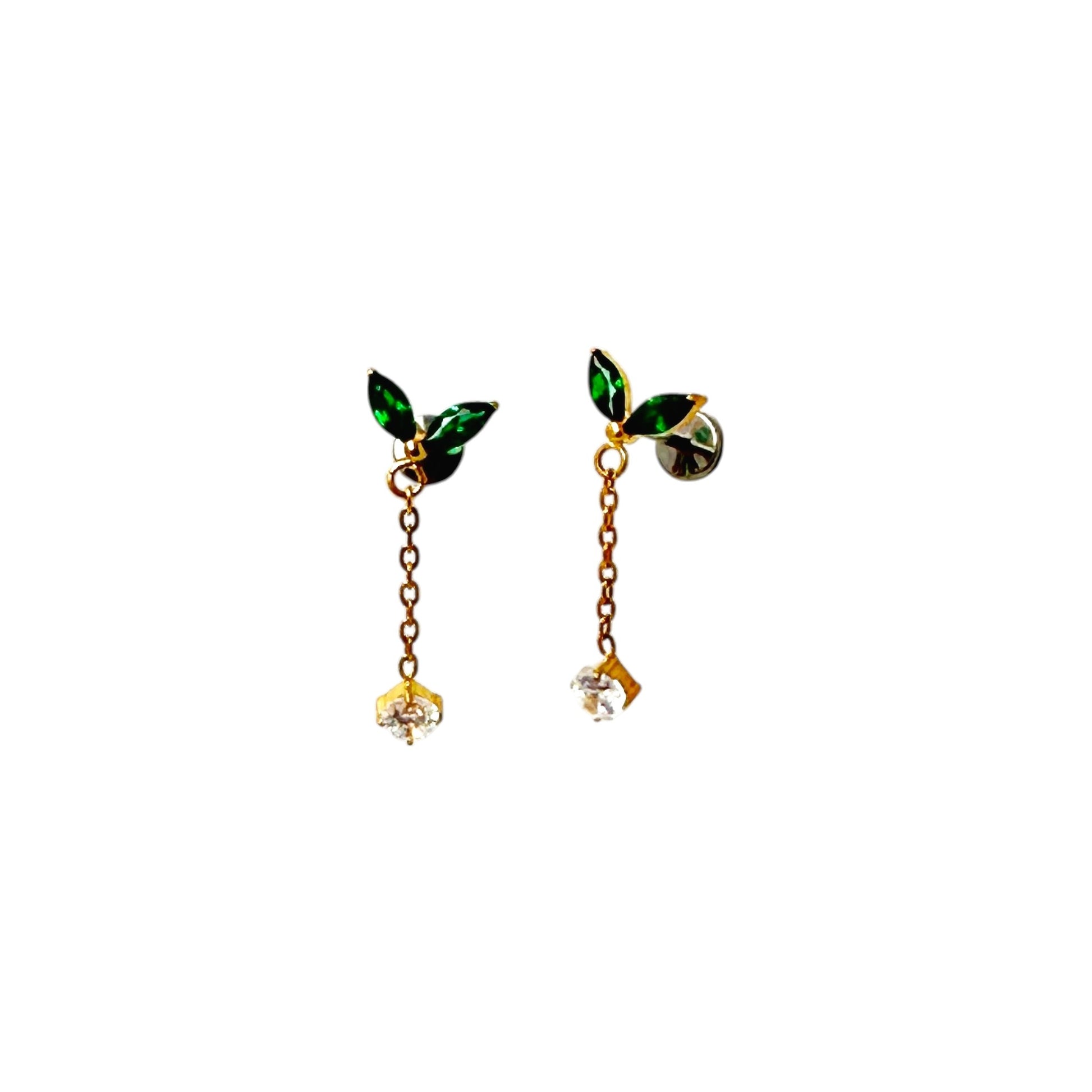 Pair of titanium flat back threadless 20 gauge earrings with green leaf-like tops and gold chains on a white background