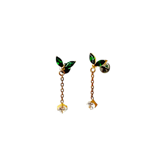 Pair of titanium flat back threadless 20 gauge earrings with green leaf-like tops and gold chains on a white background