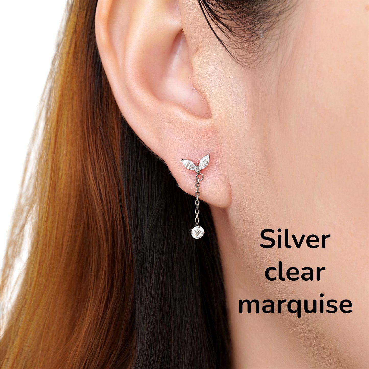 Close-up of an ear wearing a silver clear   titanium flat back earring on a woman