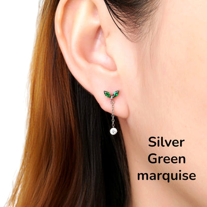 Close-up of an ear wearing a silver green leaf-shaped titanium flat back earring on a woman
