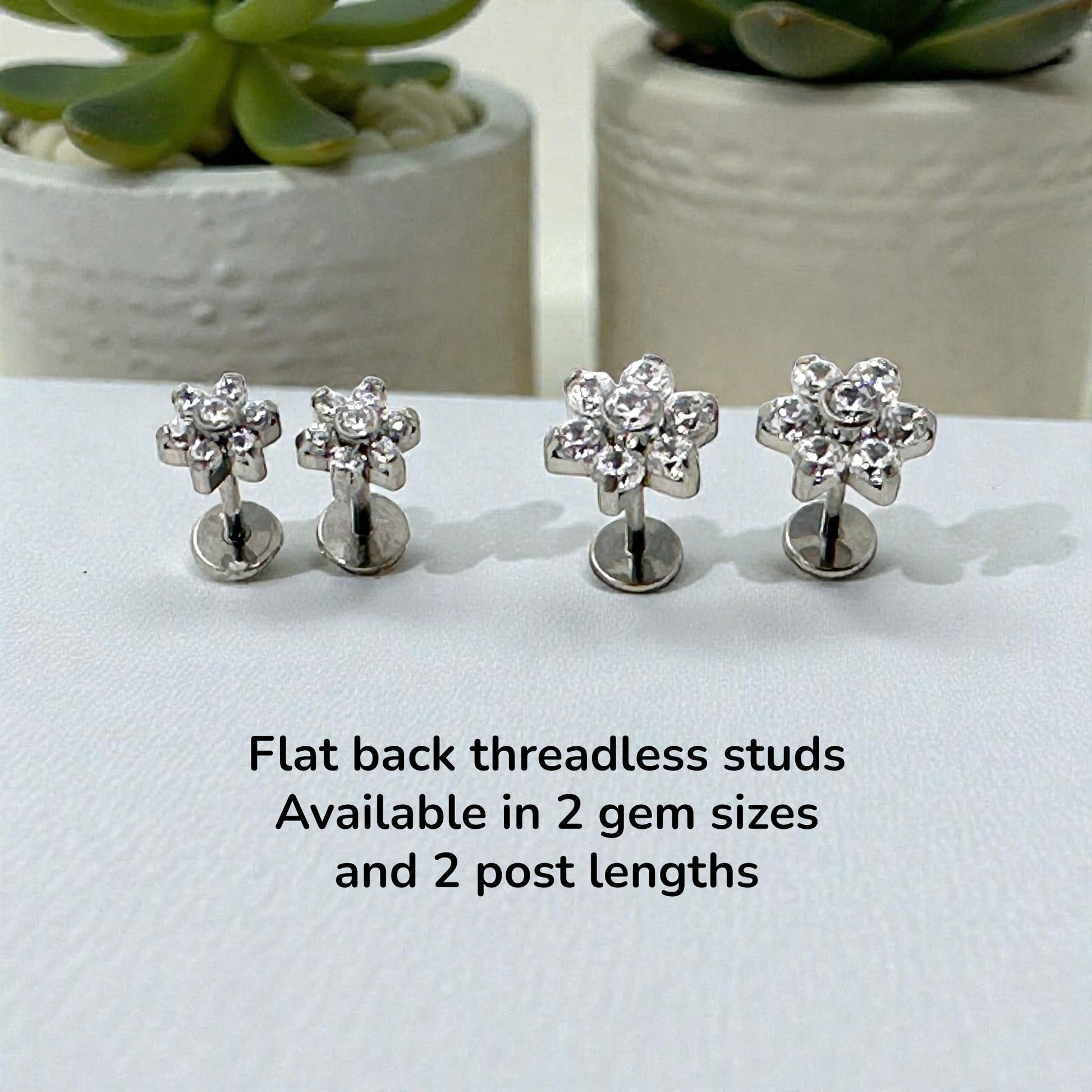 Titanium flower-shaped earrings on a white surface with text about product details.