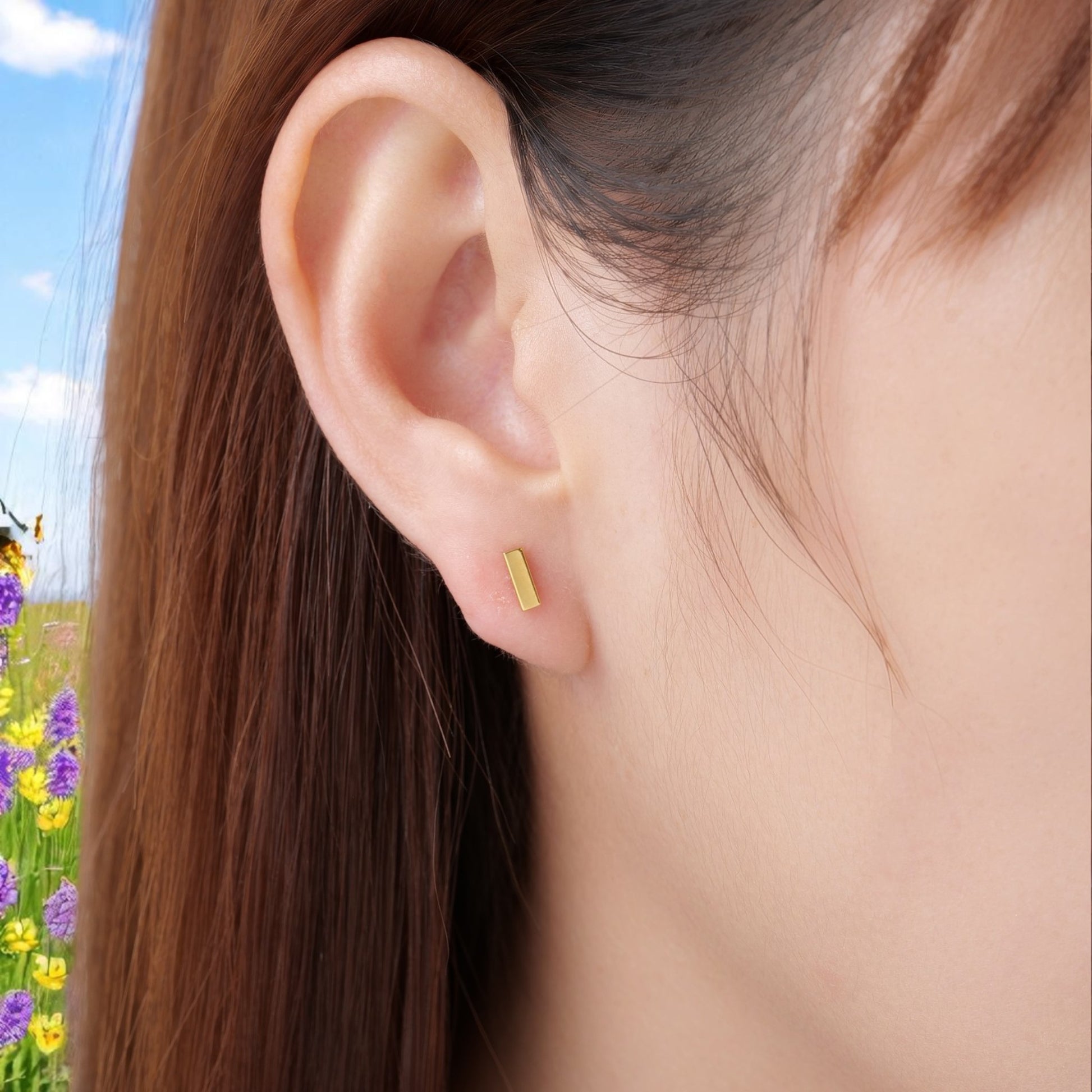 Titanium gold bar flat back threadless push in stud on a white woman closeup