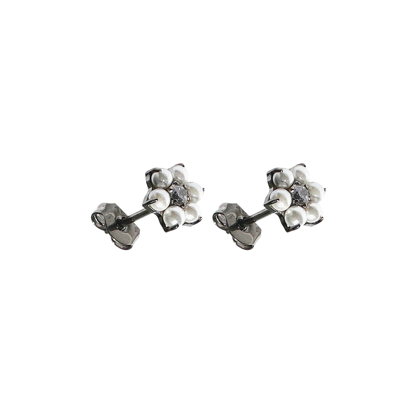 Pair of floral titanium stud earrings with pearls and a gem on a white background