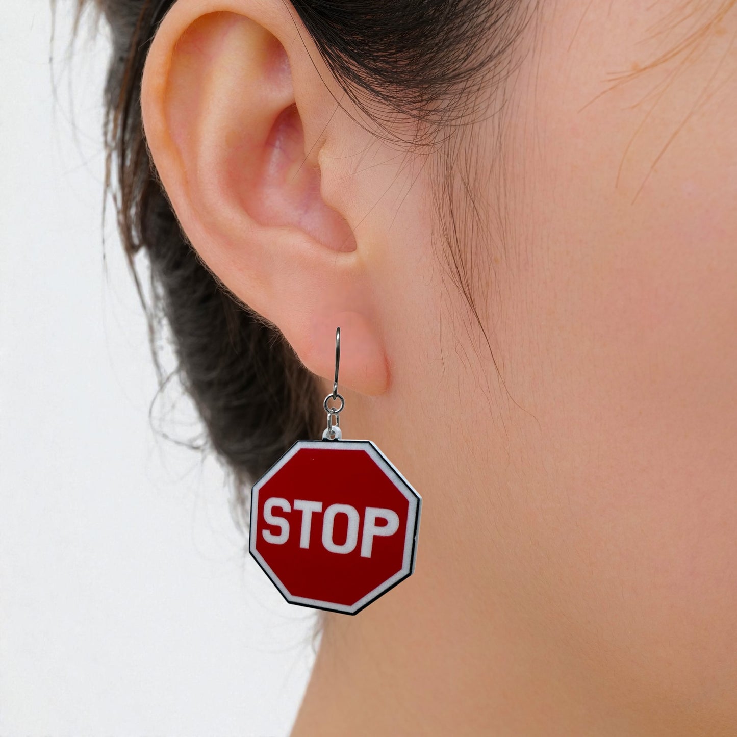 titanium stop sign earrings on a white woman