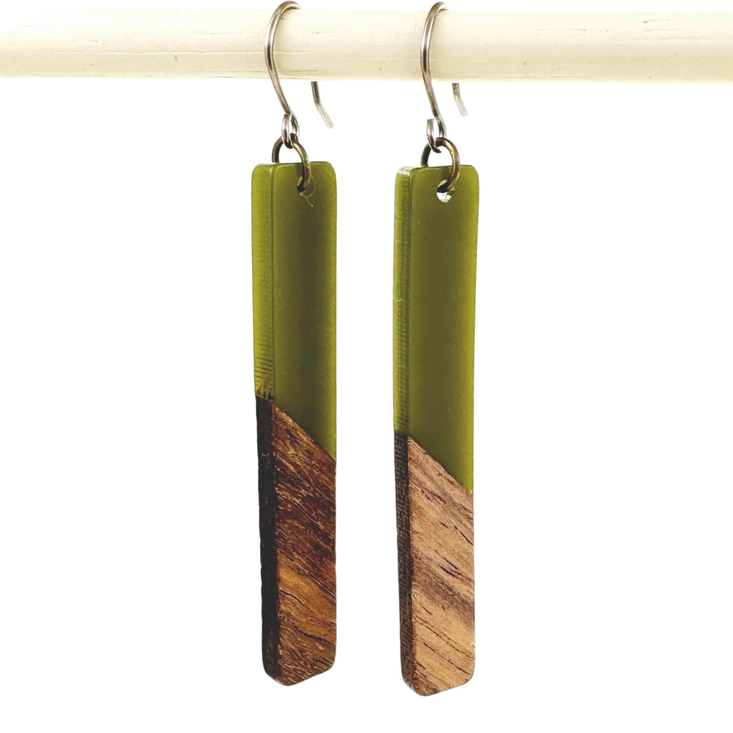 Translucent wood earrings with titanium hook. on a white background green