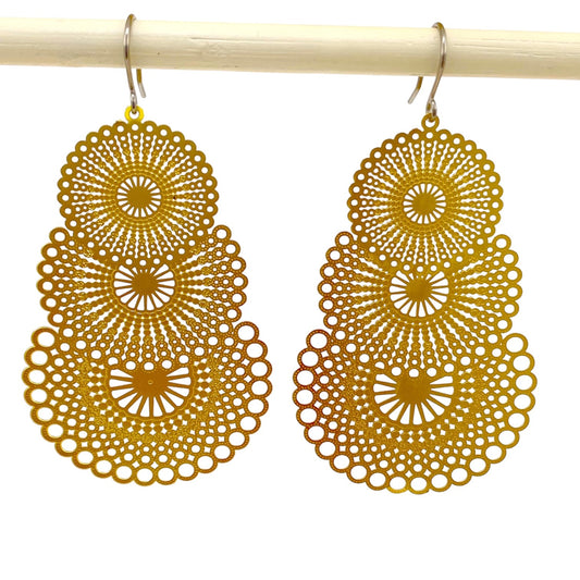 Triple gold disc drop earring with titanium hook. on a white background