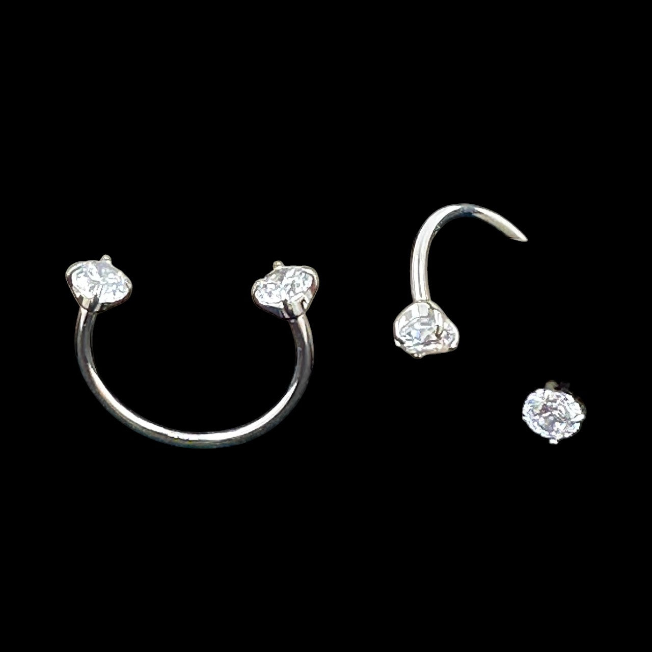 U-hoops titanium earring set with clear gemstones on a black background