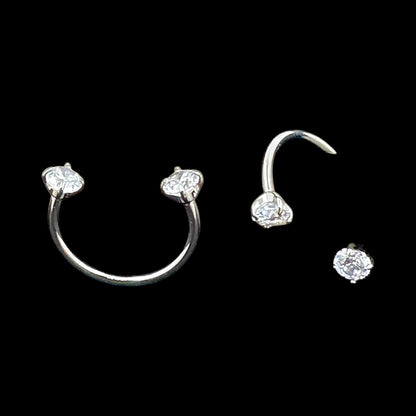 U-hoops titanium earring set with clear gemstones on a black background